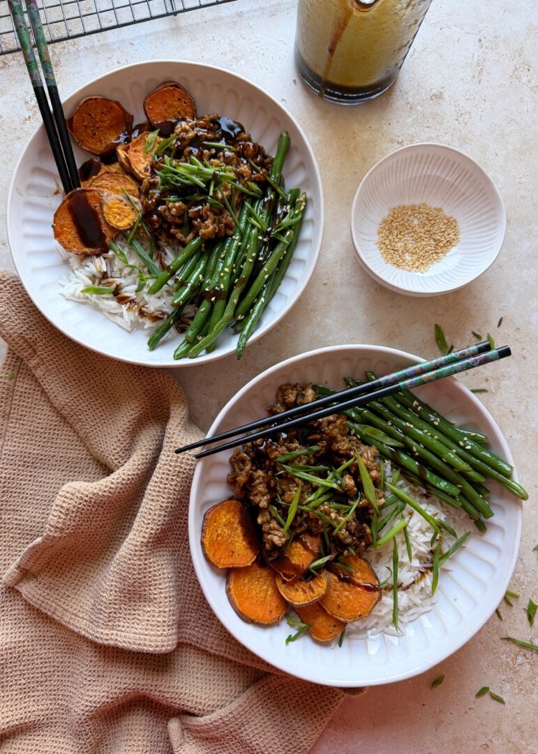 two bowls of hoisin chicken stir fry with sesame green beans and roasted sweet potatoes