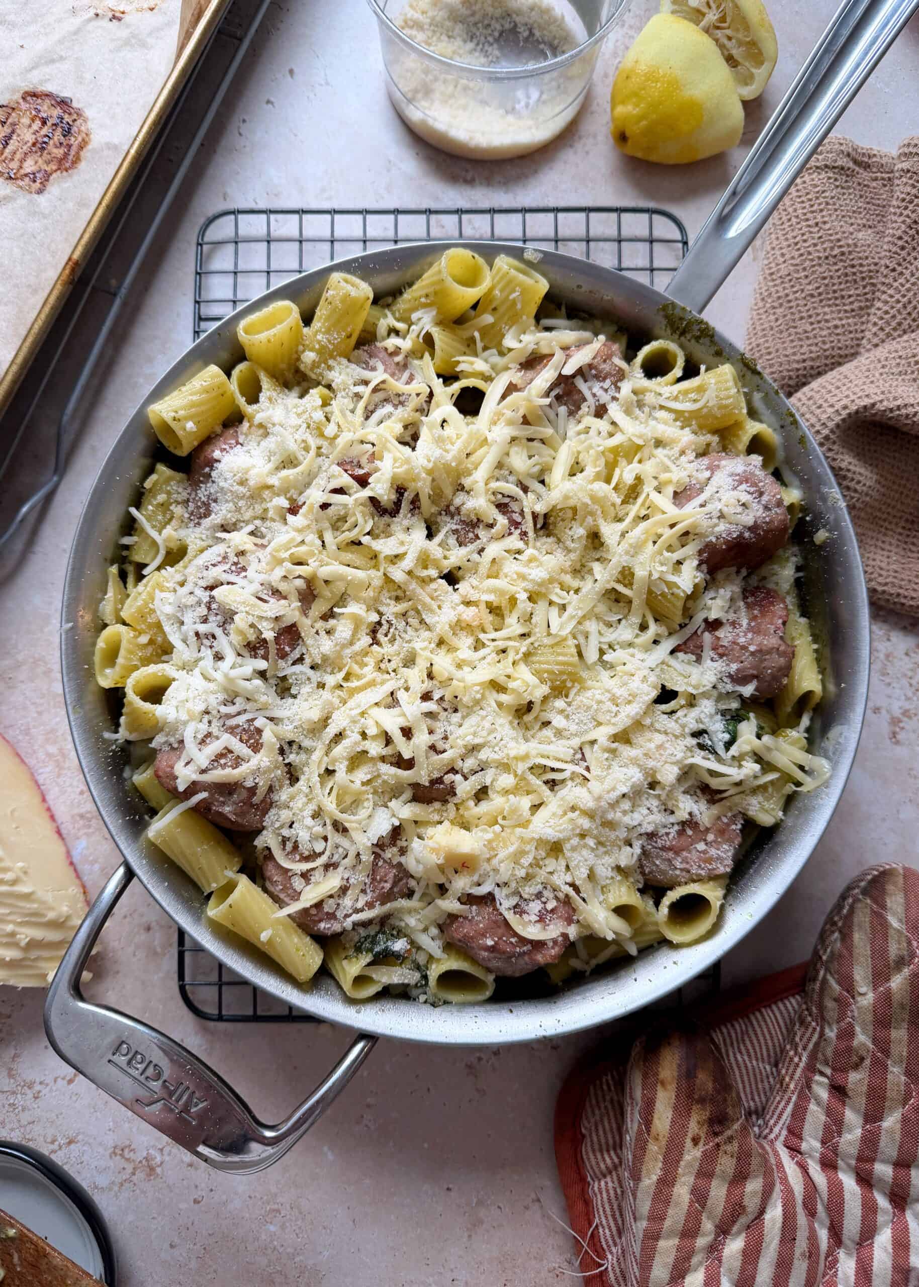 cheesy pesto turkey meatballs in saute pan before baking