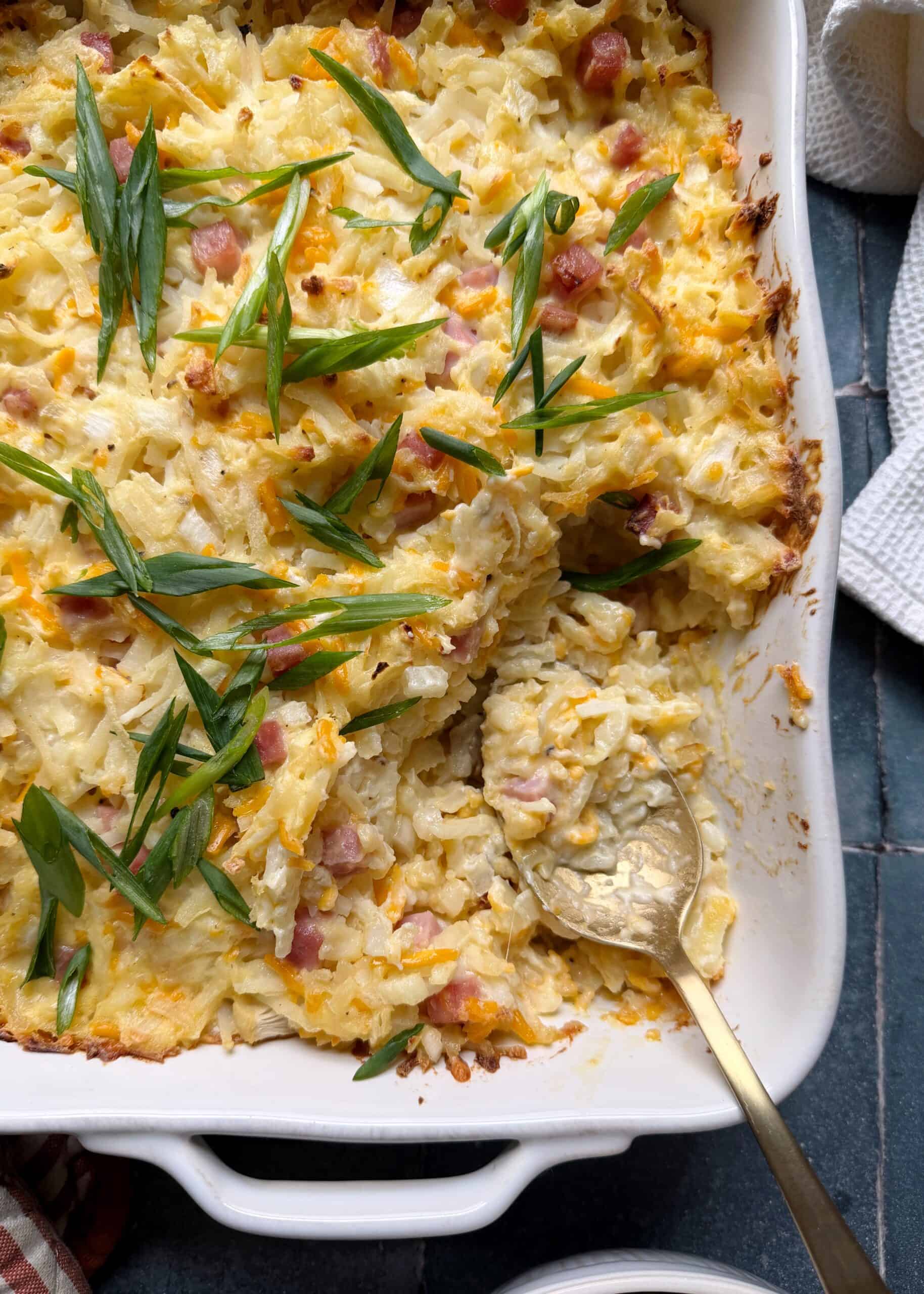 casserole dish with cheese and ham hash. browns