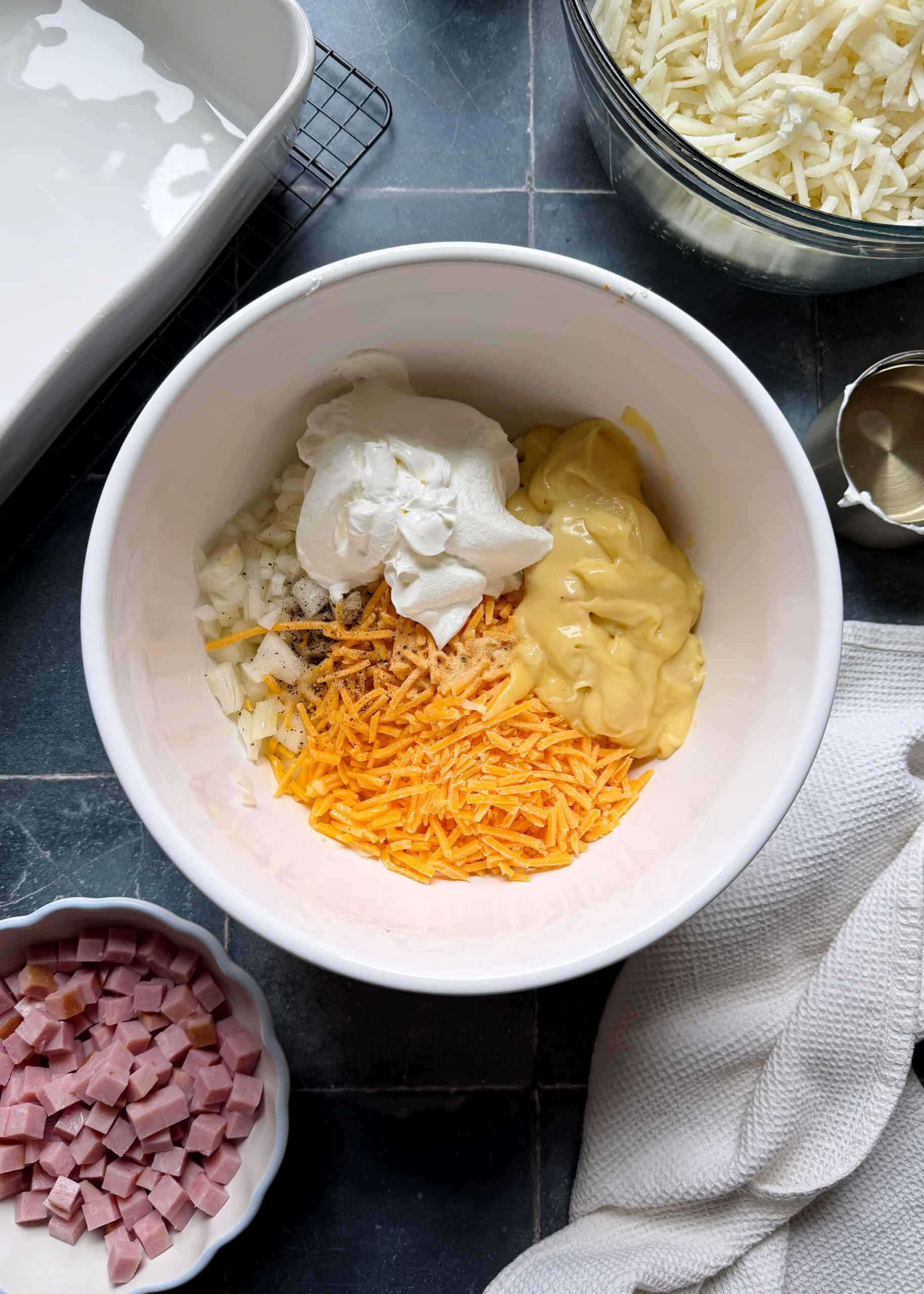 cheese mixture ingredients in mixing bowl for hash browns