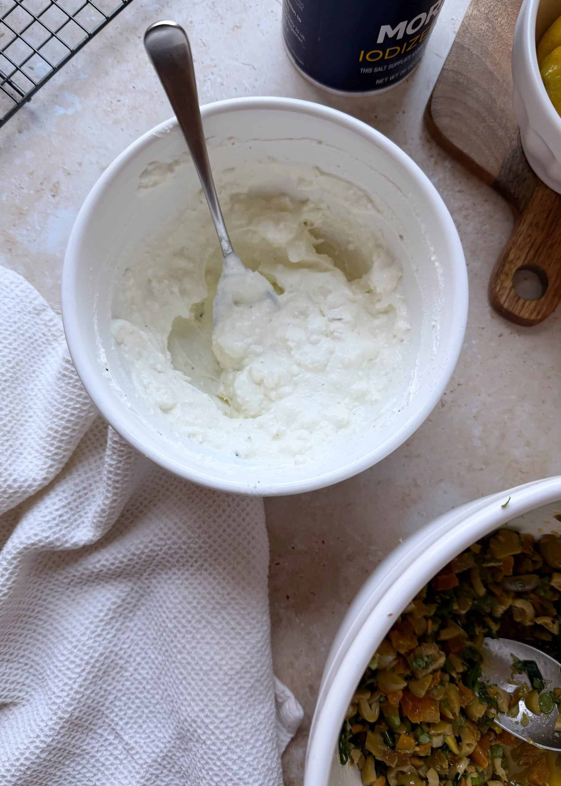 feta and yogurt sauce in a white mixing bow.