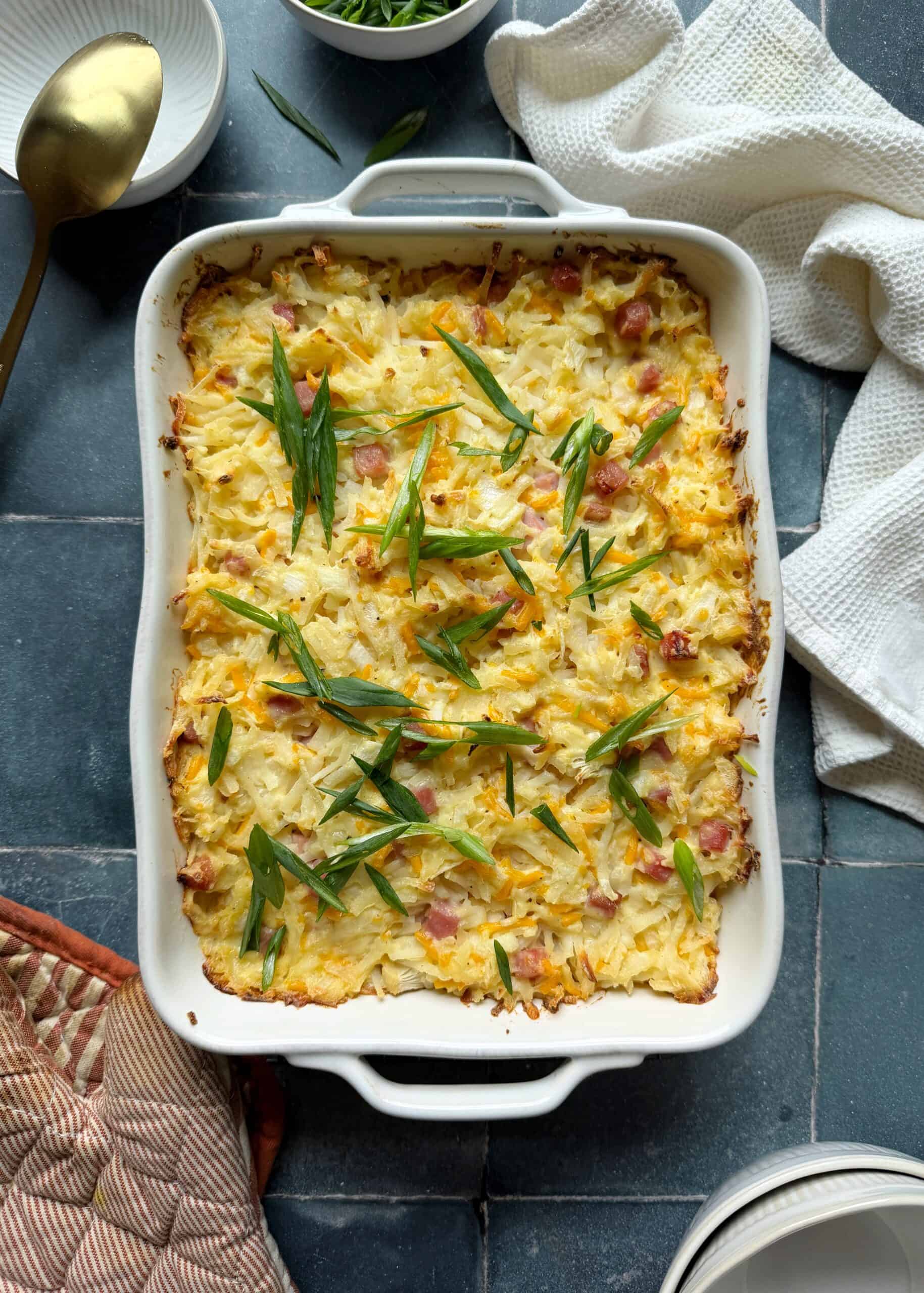 ham and cheese hash brown casserole with green onion garnish
