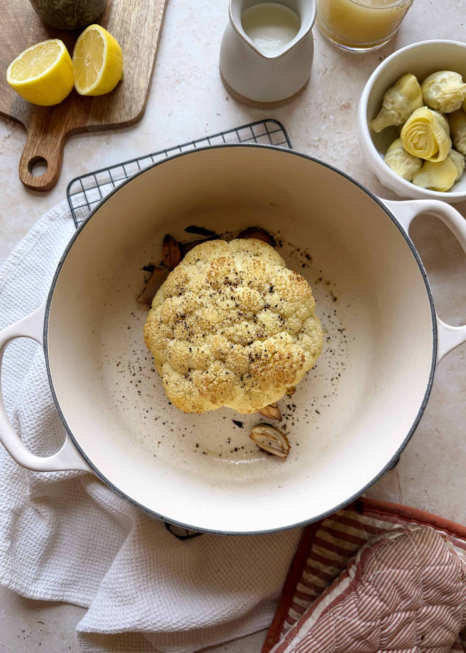 roasted head of cauliflower in white dutch oven