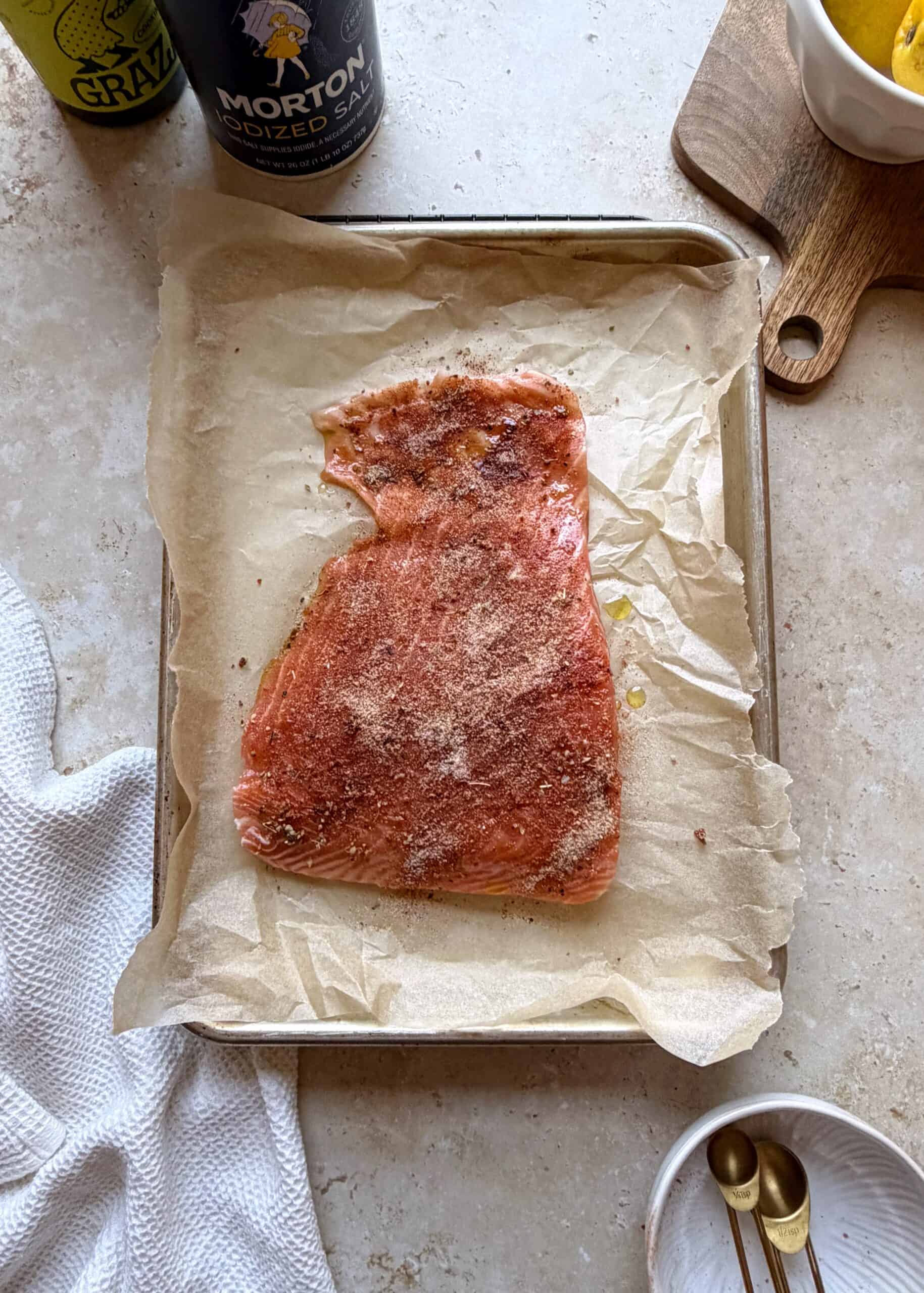 seasoned filet of salmon on a small baking sheet
