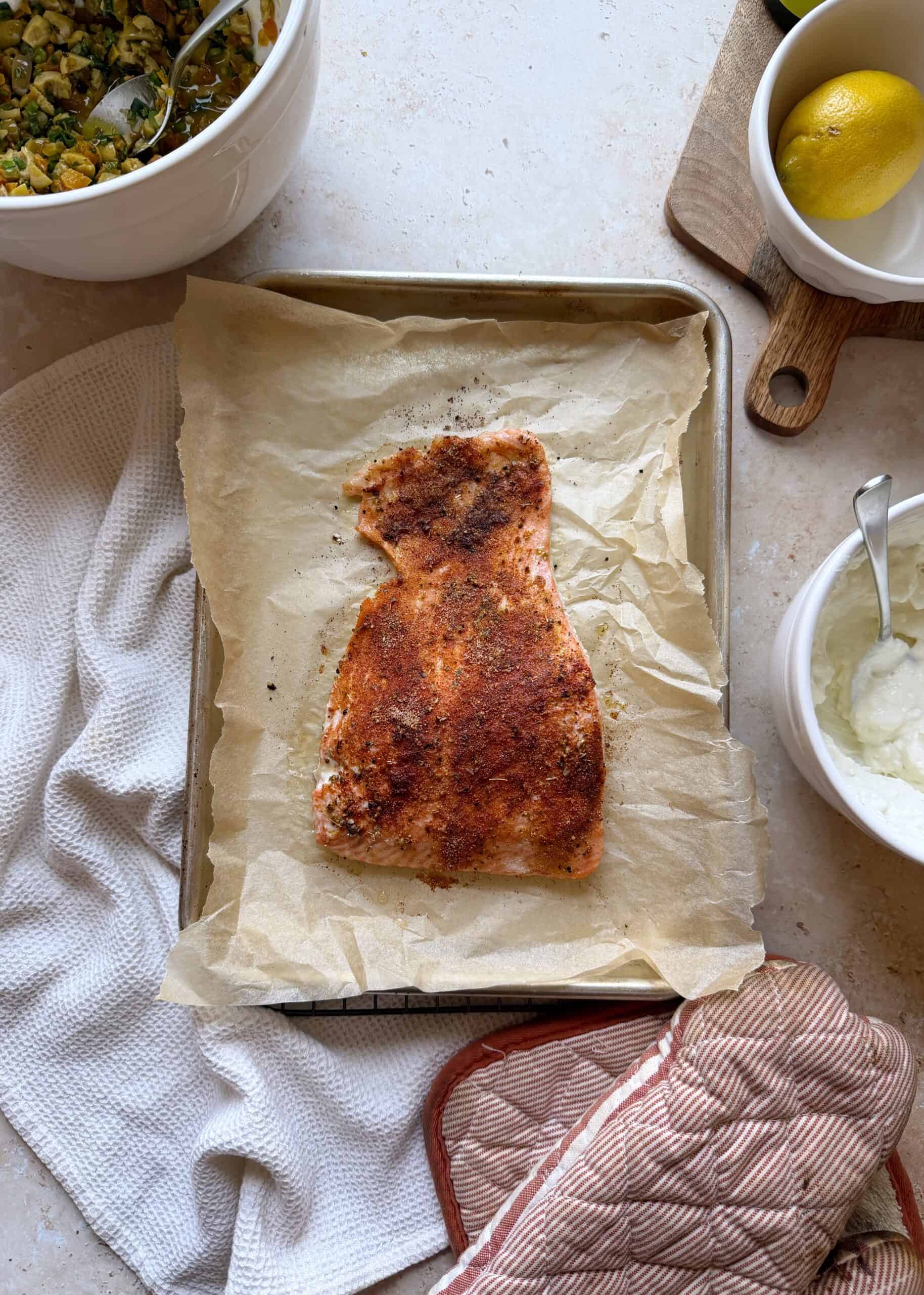 seasoned roasted salmon filet on a baking sheet