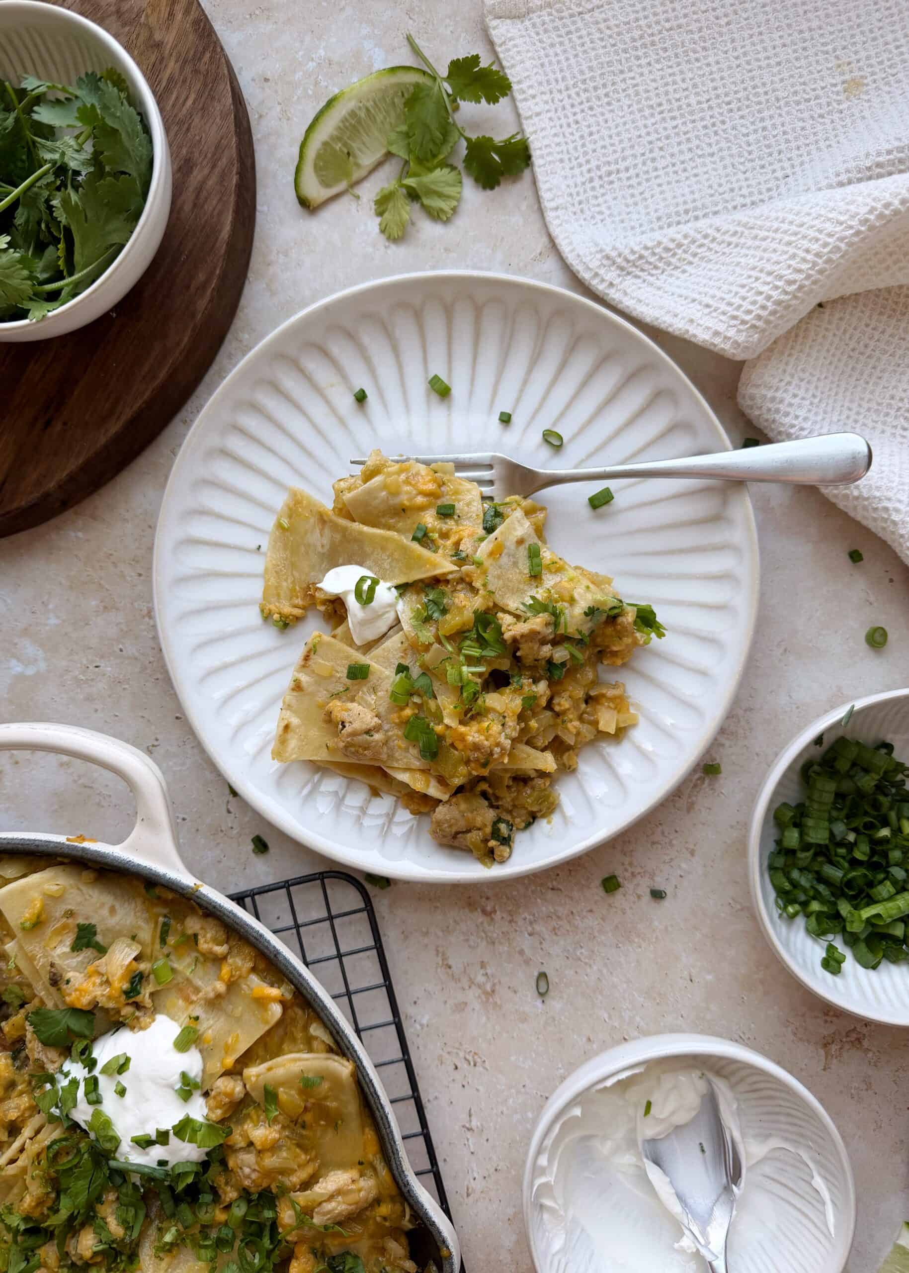 serving of green chile chicken enchilada skillet on a white plate