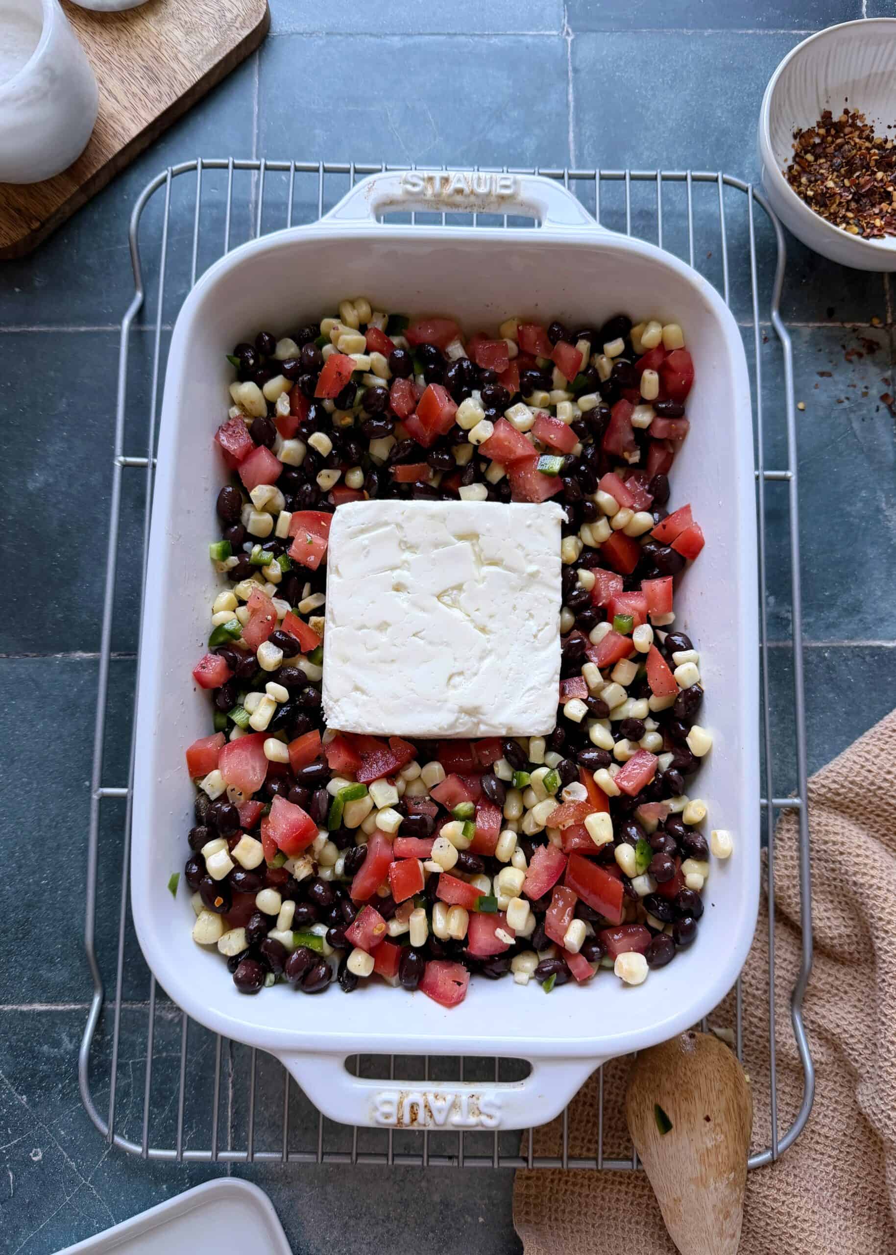 black bean dip with corn tomatoes and feta before baking