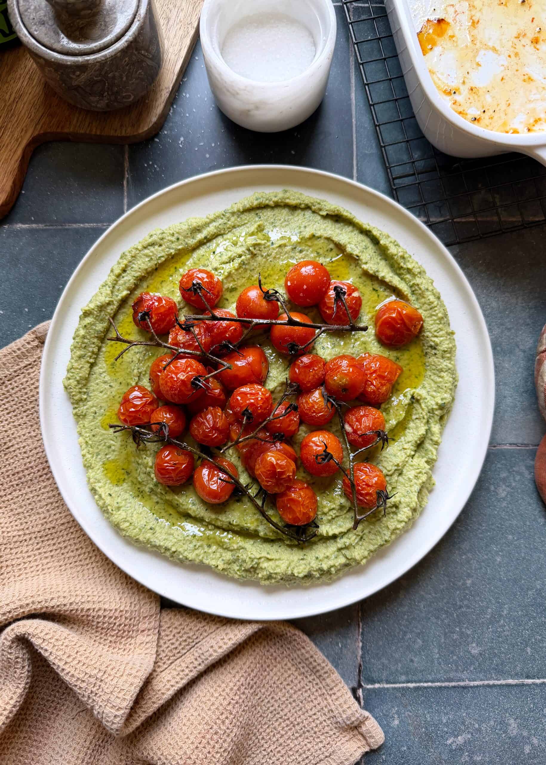 herby jalapeno hummus topped with roasted cherry tomatoes