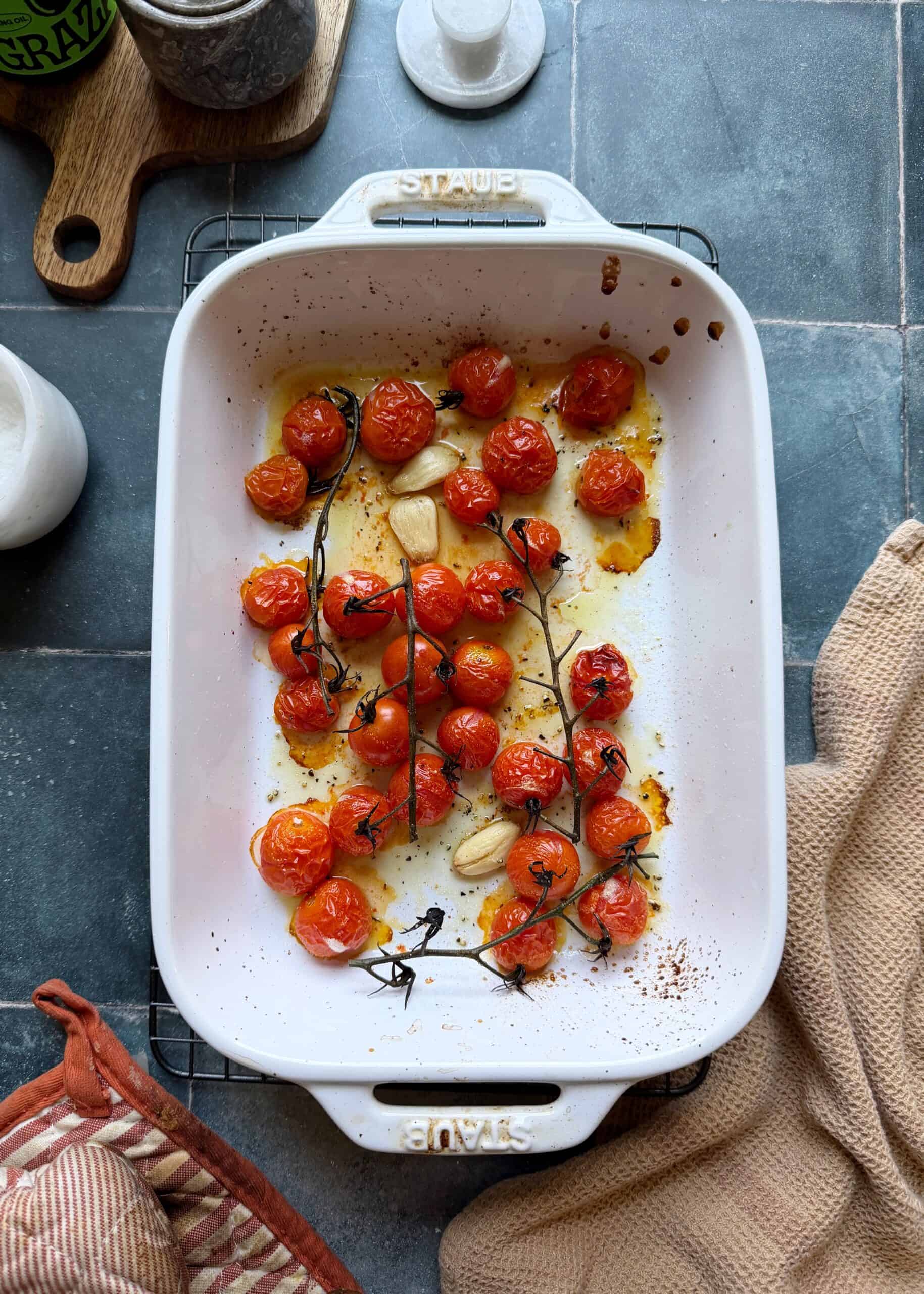 roasted cherry tomatoes in a white casserole dish